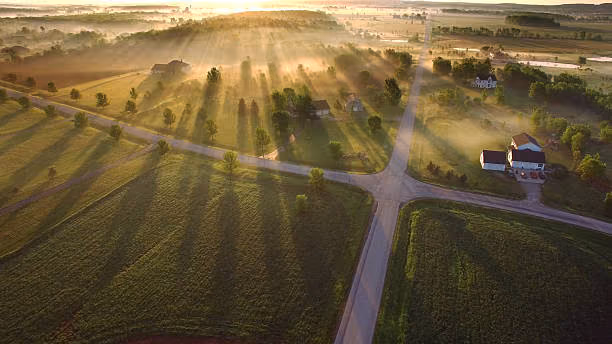 Magical sunrise through ground fog with long shadows and sunbeams.